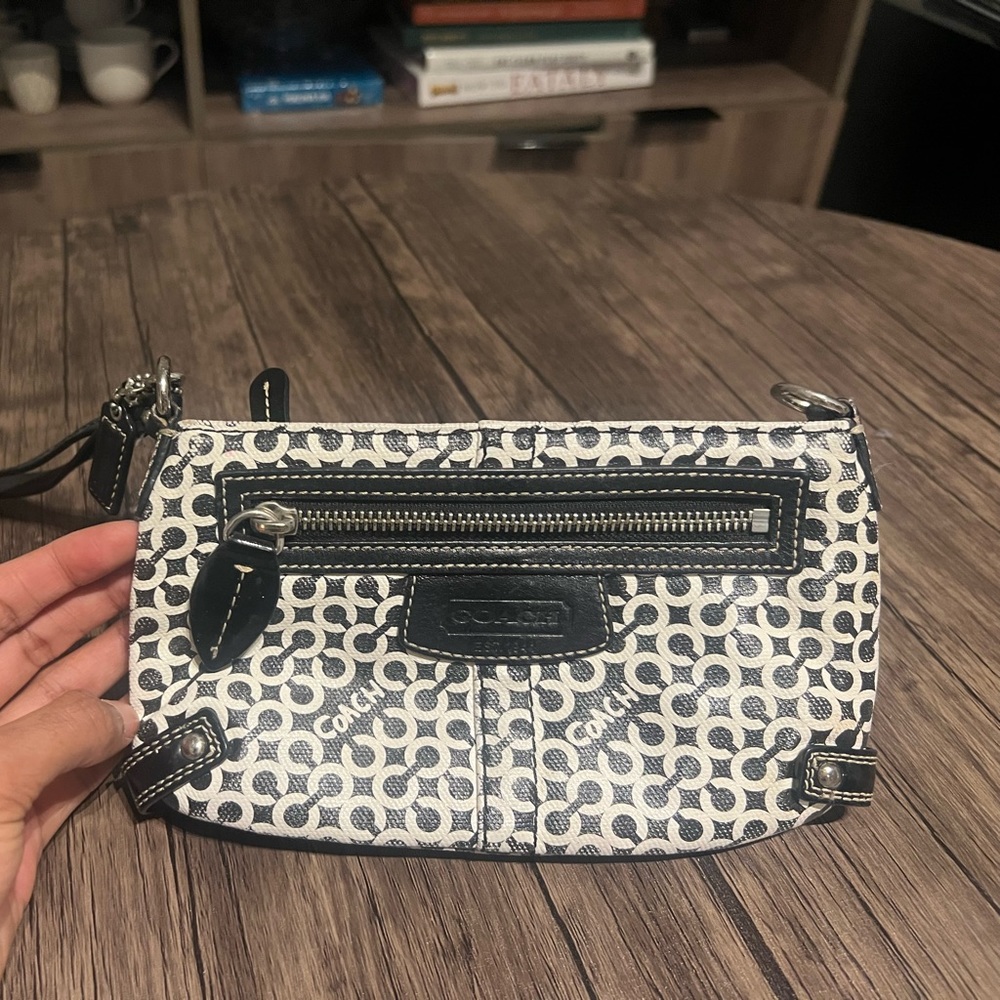 Medium sized black and white Coach wristlet.